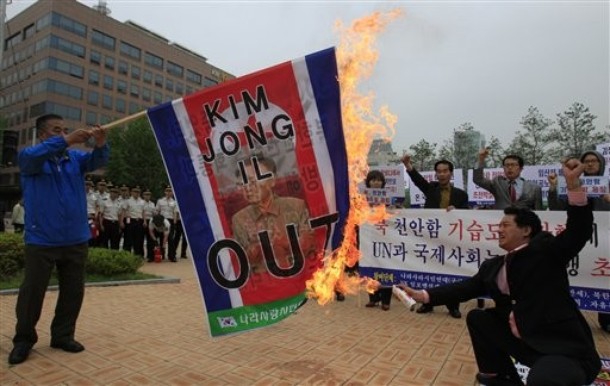 north korean flag and south korean flag. South Korean activists burn a