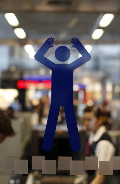 female airport body scanners. A sign for a full ody scanner